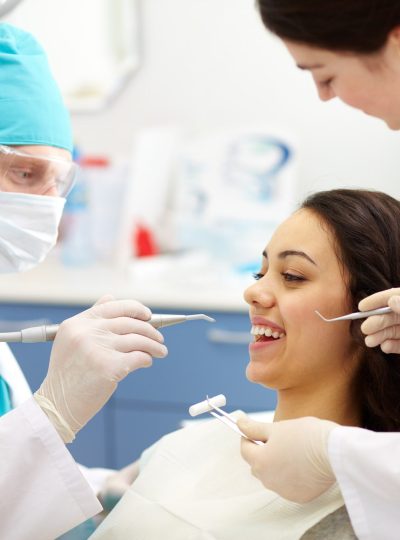 dentist-examining-patient-s-teeth-min